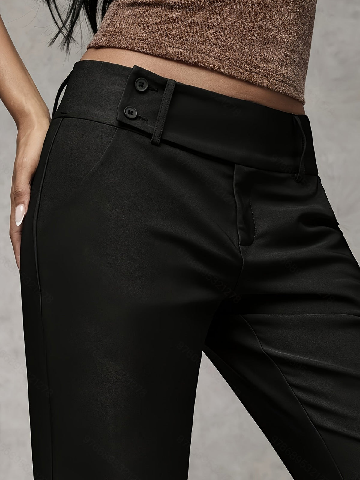 Close-up of the refined fabric texture on dark grey trousers, highlighting the subtle finish and quality.