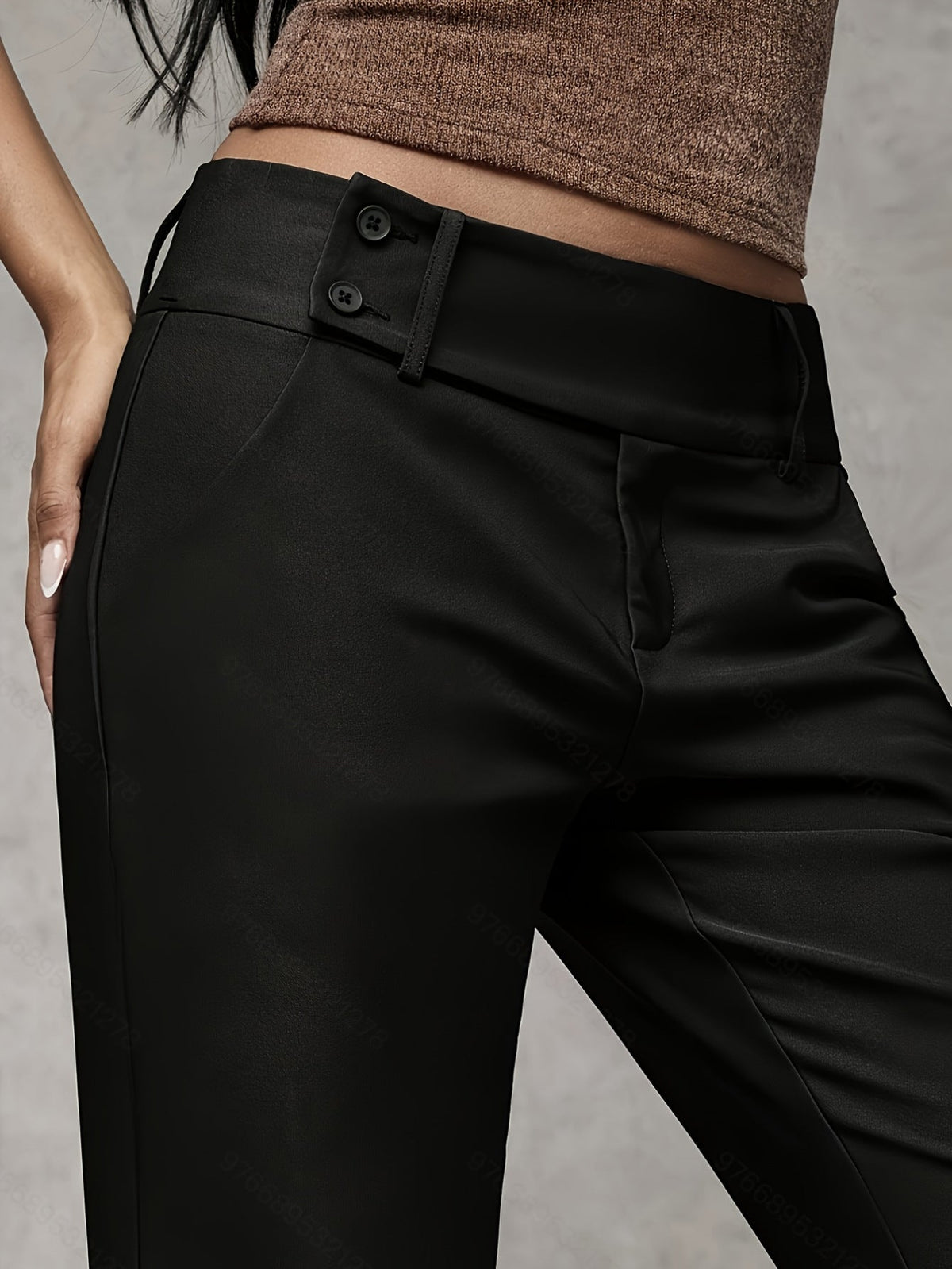 Close-up of the refined fabric texture on dark grey trousers, highlighting the subtle finish and quality.