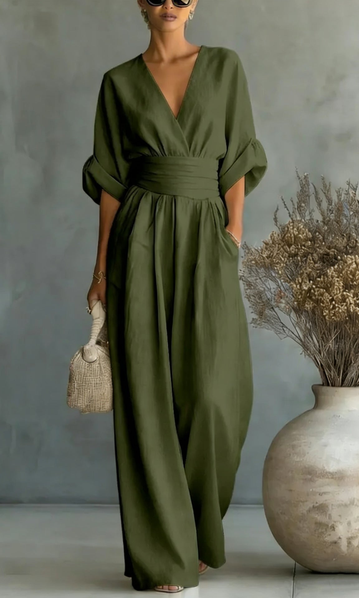 Detailed shot illustrating the subtly integrated pockets on the olive green fashionable jumpsuit.