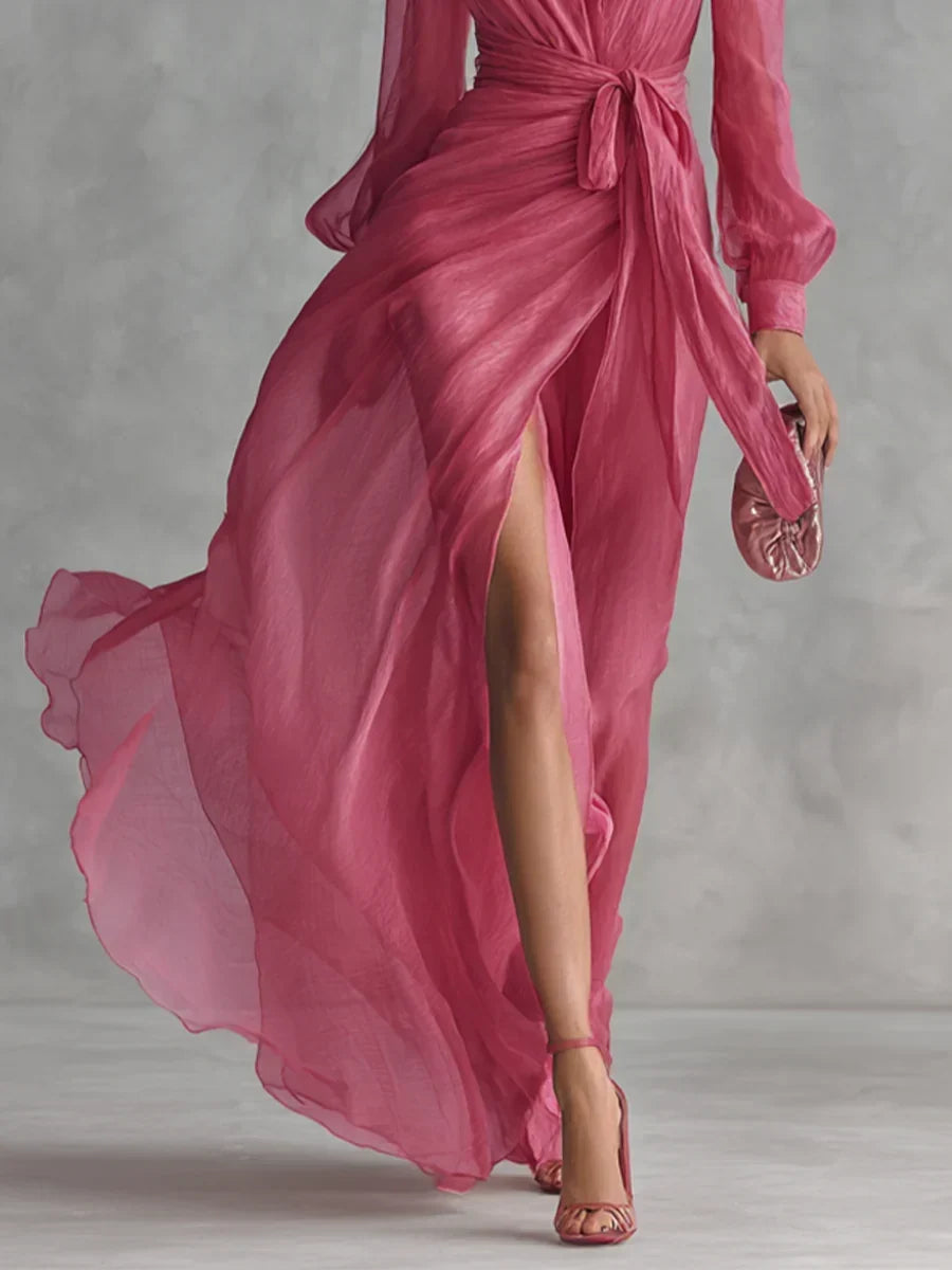 Side profile of the long-sleeved chiffon maxi dress, emphasizing the soft slit and delicate pearlescent fabric for evening wear.
