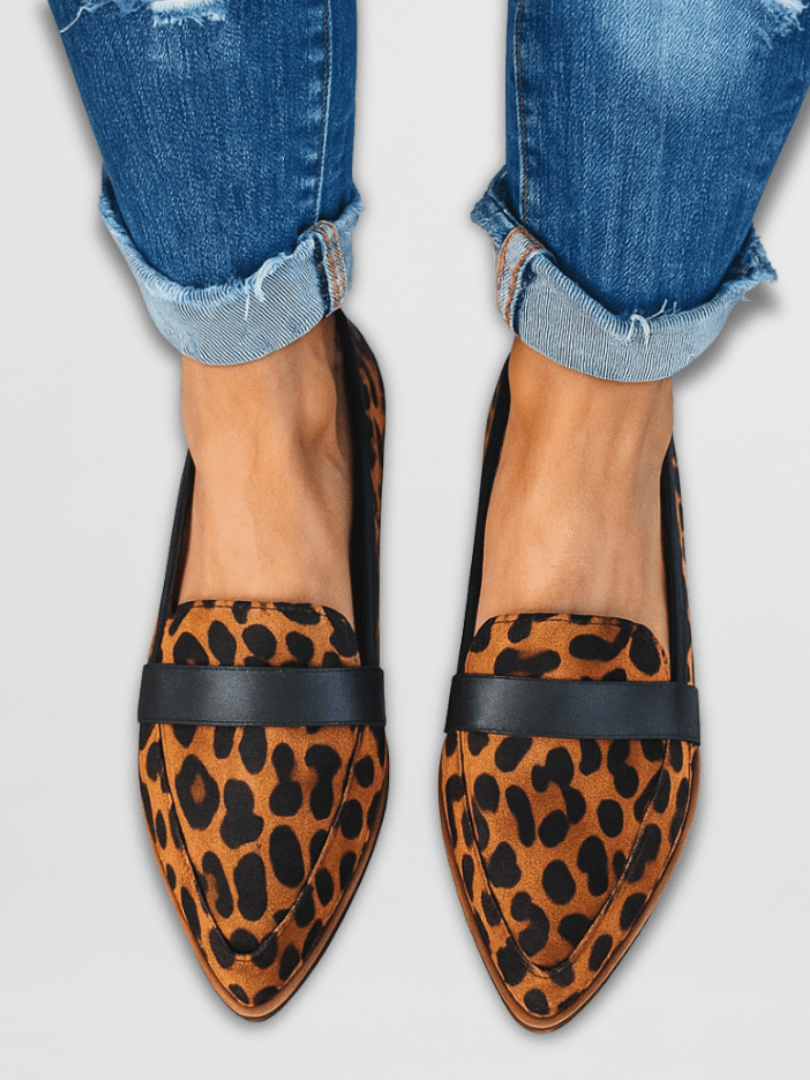 Detail shot of the back of a grey suede loafer, focusing on the durable, shock-absorbing outsole and heel construction.