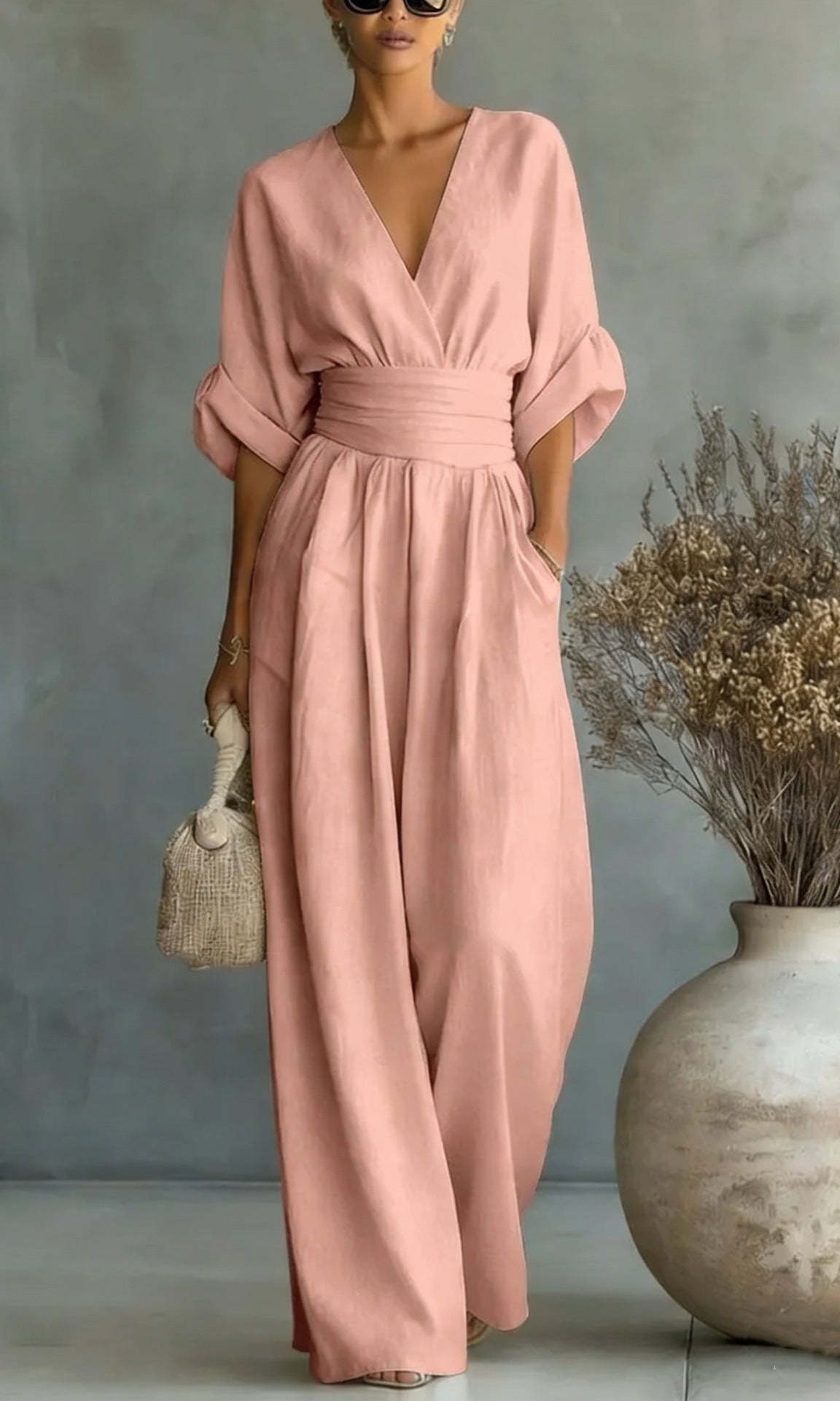 Another color option, a pink jumpsuit, worn by a model, perfect for festive occasions.