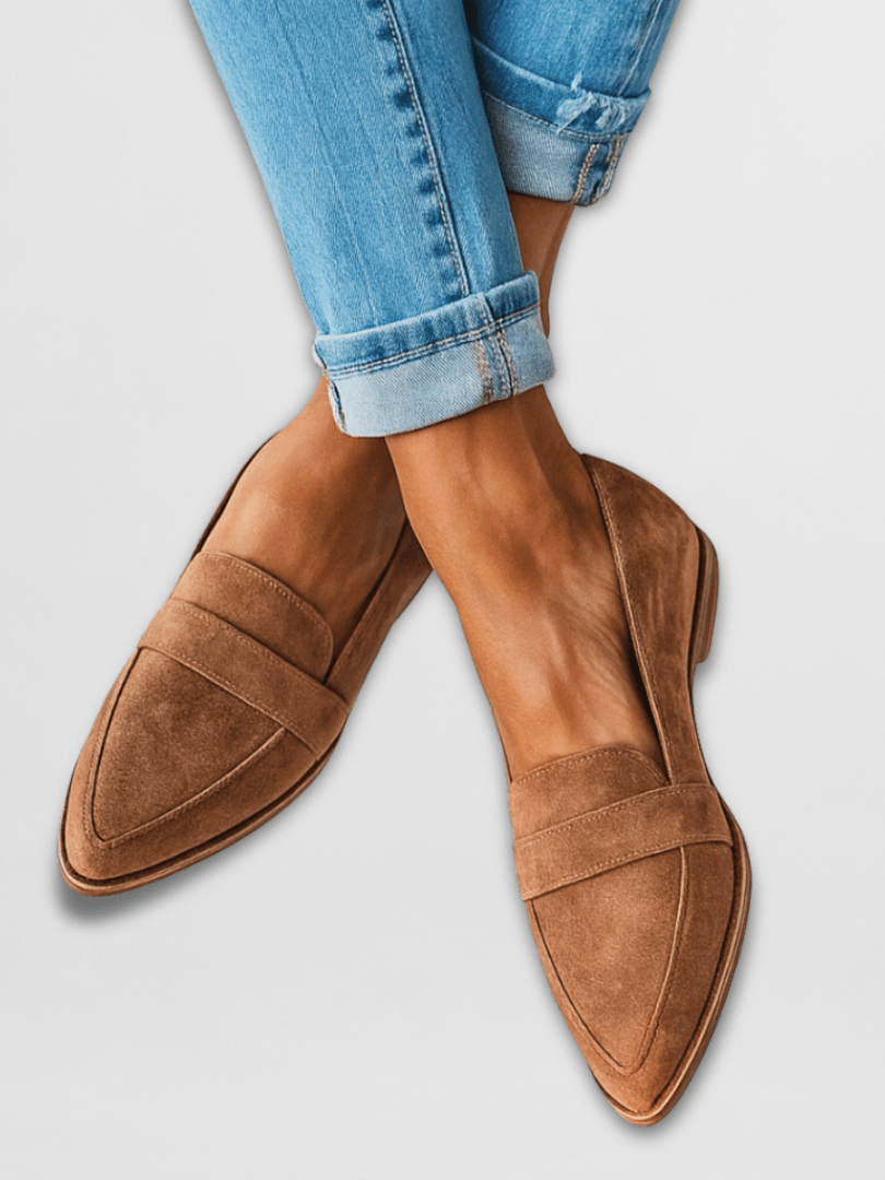 Close-up side profile of a brown suede loafer, highlighting the soft texture of the upper and the subtle heel design.