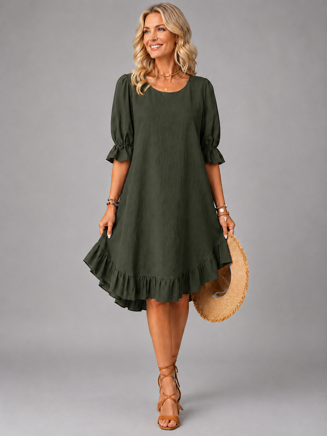Side profile of a woman in a green Zenia dress, highlighting the soft drape and midi length.