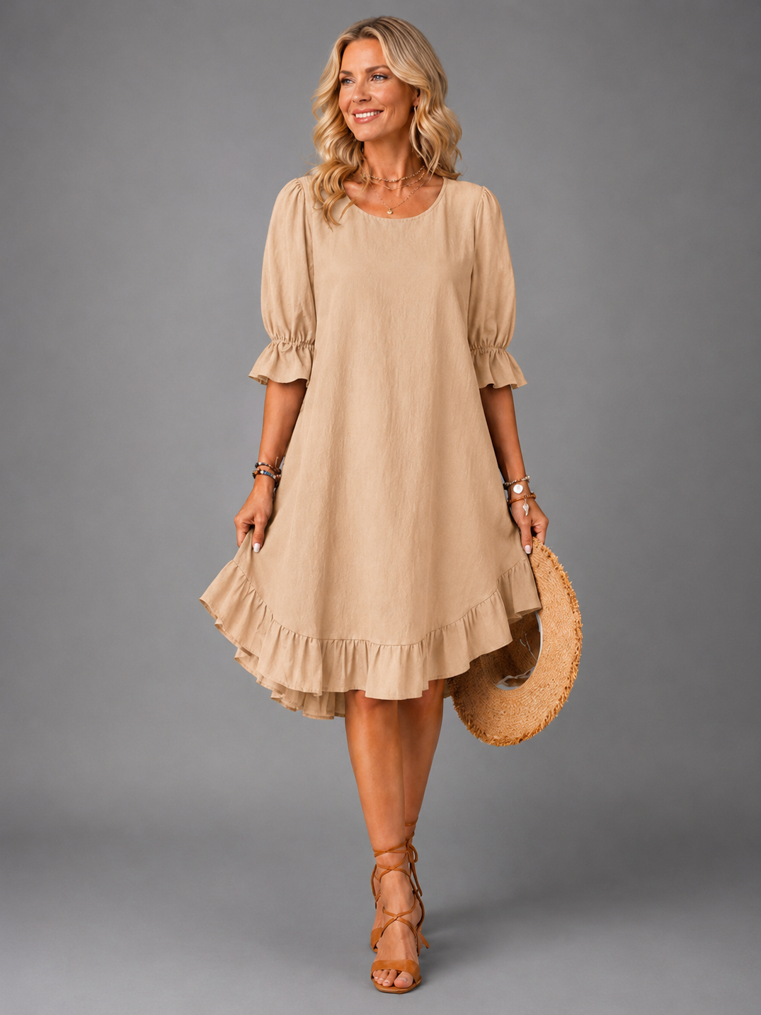 Full-length back view of a woman wearing a khaki Zenia dress, demonstrating its elegant versatility.