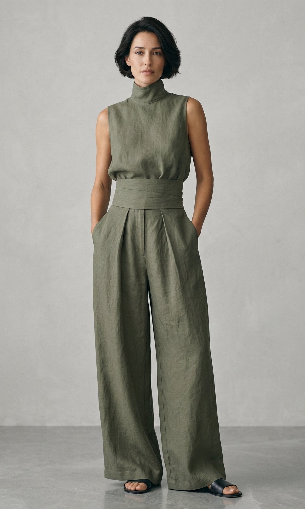 Stack of neatly folded wide-leg trousers in various appealing colors: beige, olive, light blue, and blush pink.