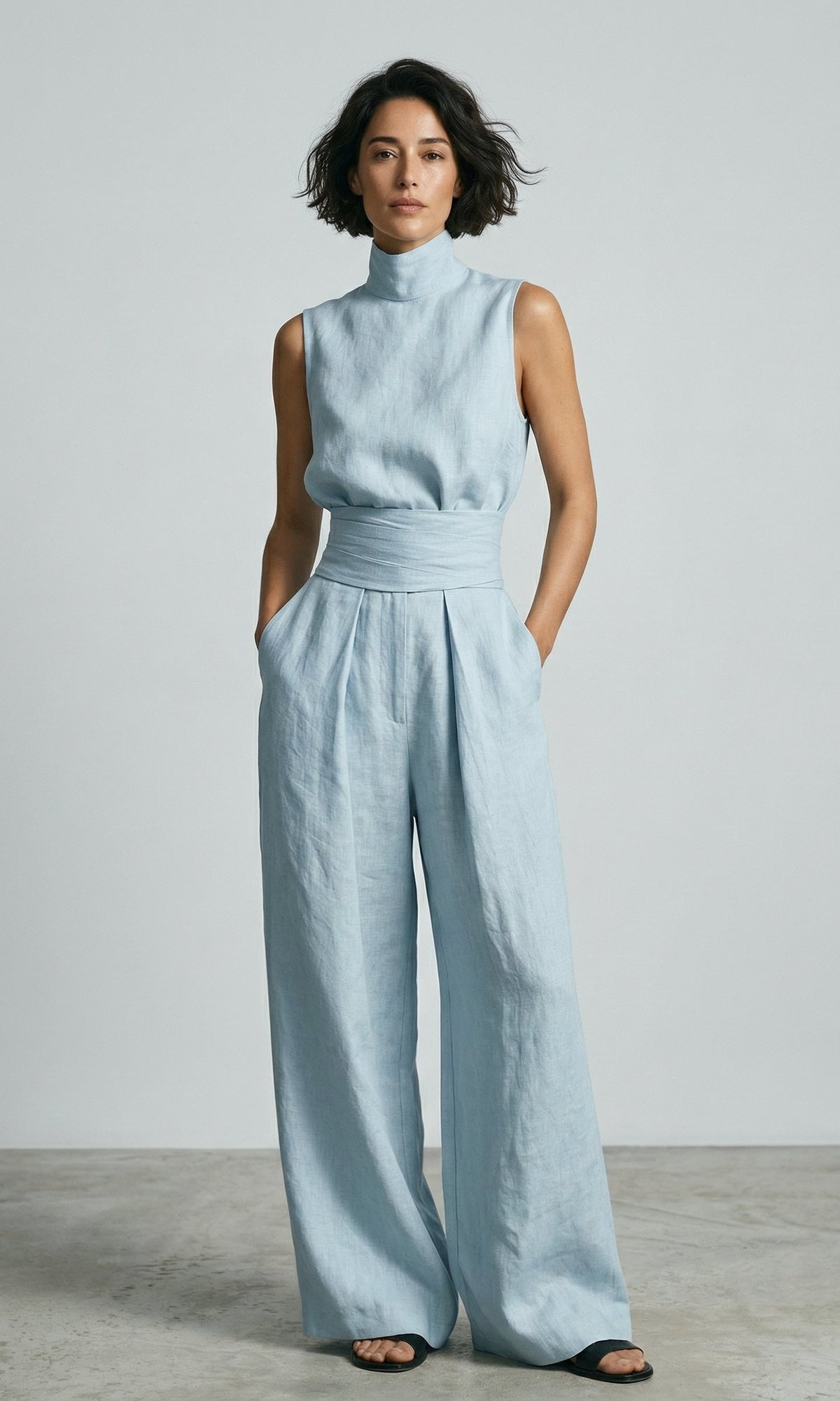 Overhead view of the wide-leg cotton trousers laid flat, showing the full, generous cut and material.