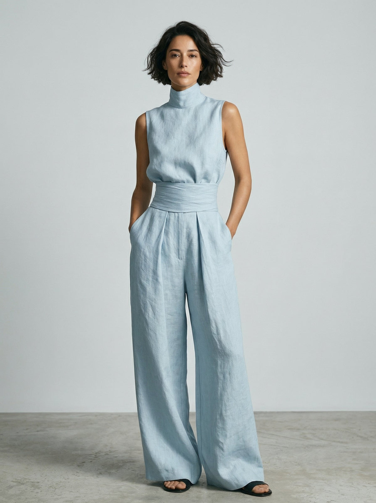 Overhead view of the wide-leg cotton trousers laid flat, showing the full, generous cut and material.