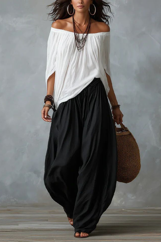 Front view of Adora black relaxed fit trousers on a model, styled with a simple top.