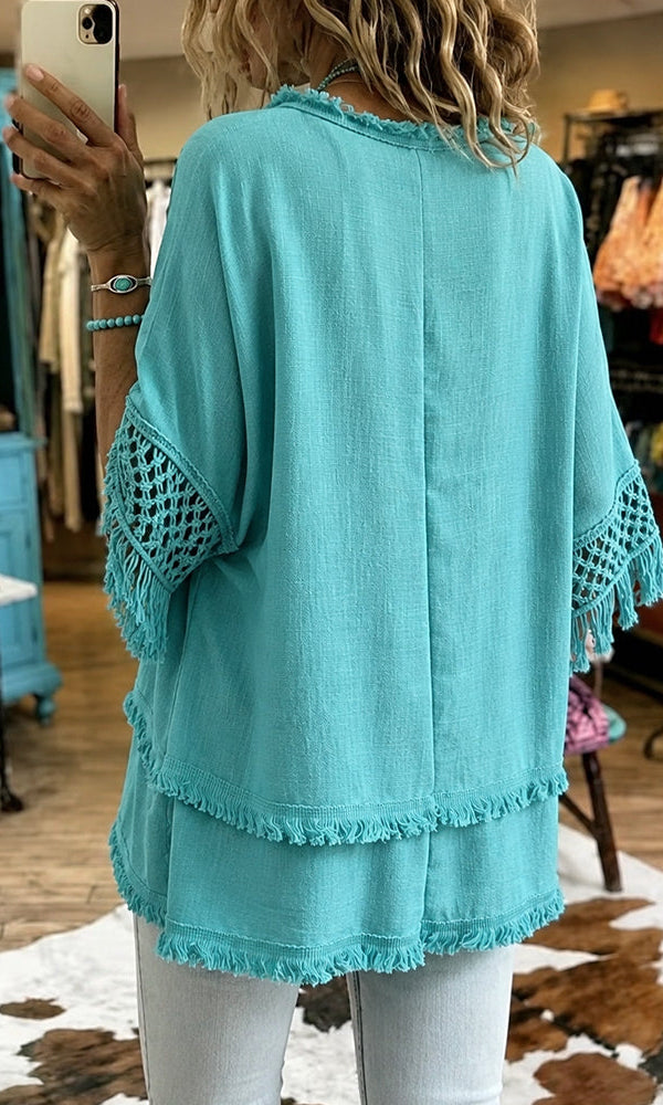 Side profile of the relaxed fit crochet blouse, highlighting its flowing shape and comfortable design.