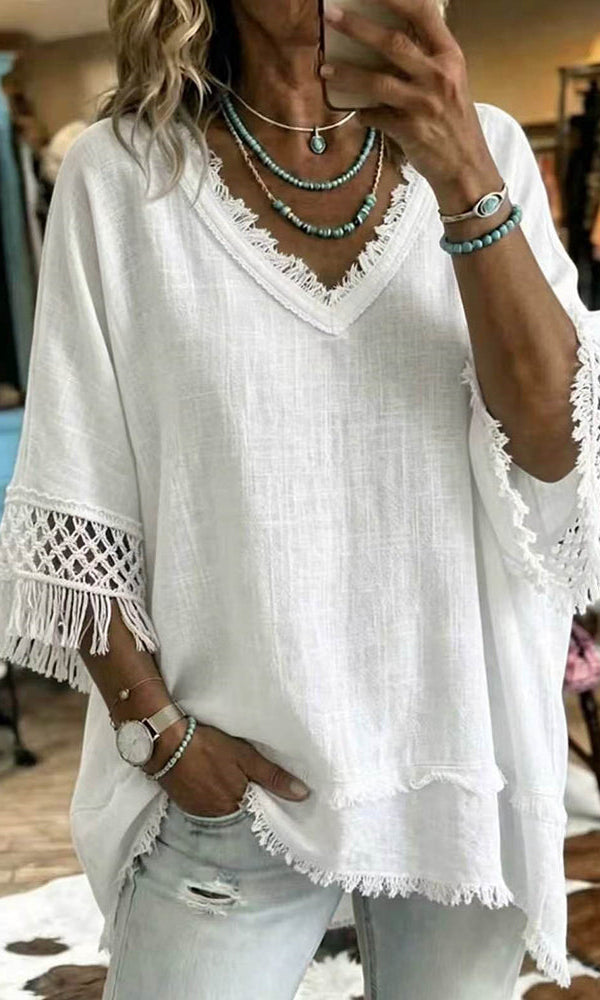 A woman wearing the aqua green easygoing crochet blouse, styled casually with jeans for a relaxed look.