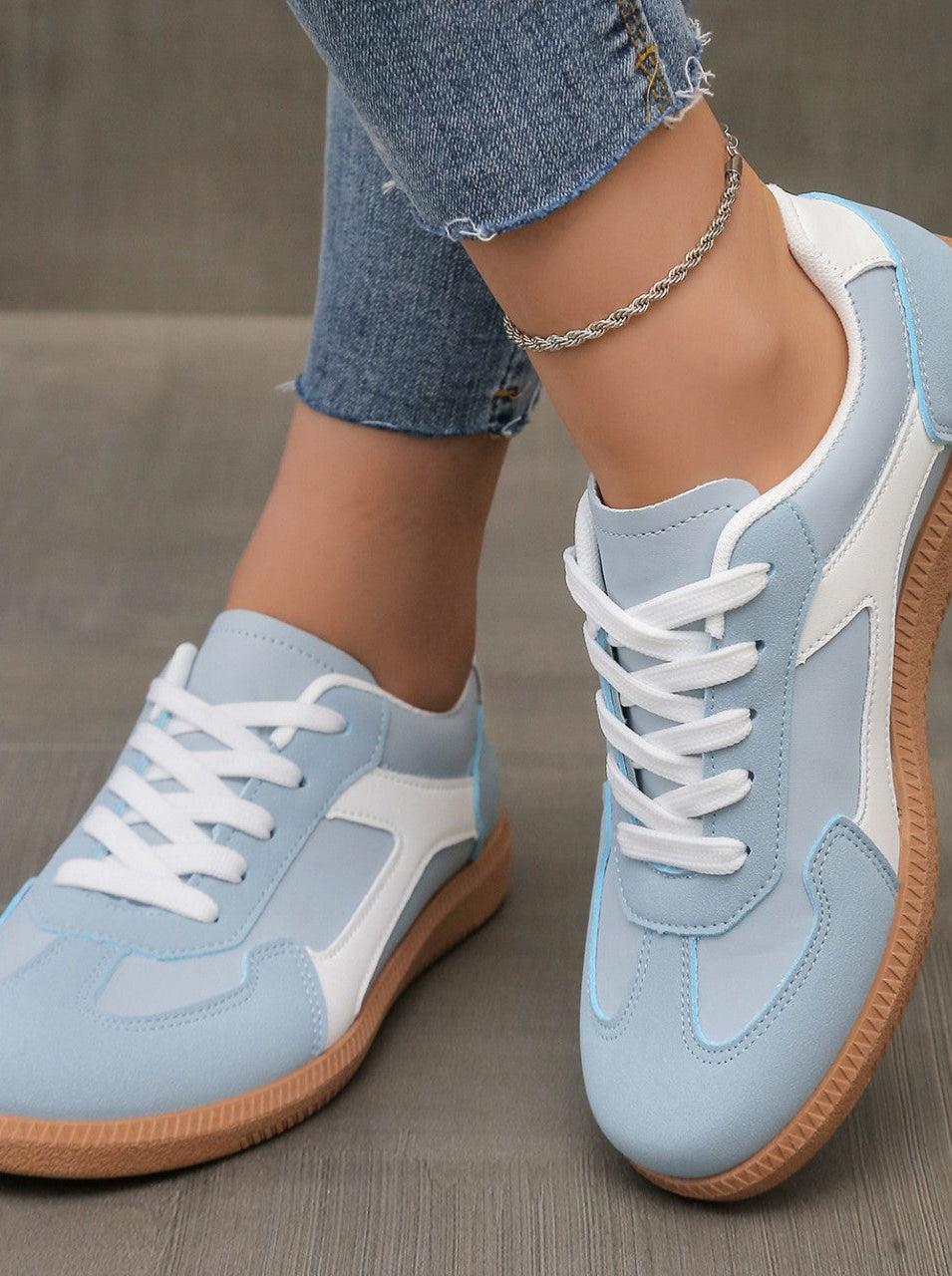 Close-up of the sky blue Adaline orthopaedic shoe, showing the breathable upper material and stitching details.