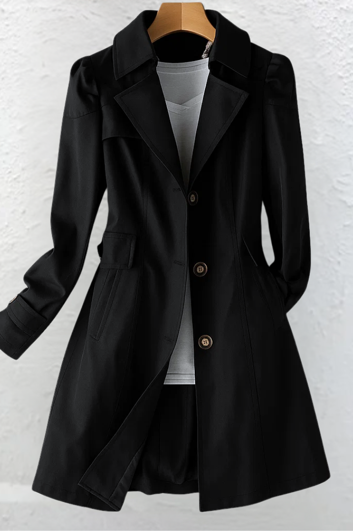 A model smiling while wearing the Adeline trench coat in pink, demonstrating its comfortable and stylish fit.