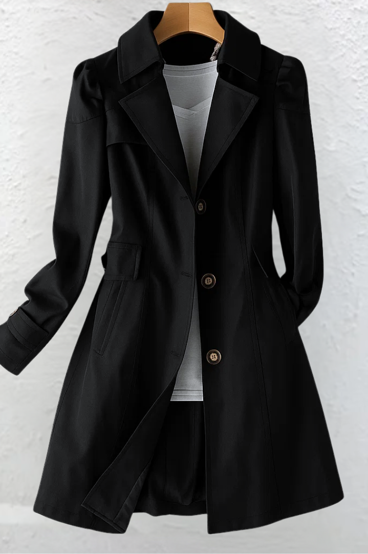 A model smiling while wearing the Adeline trench coat in pink, demonstrating its comfortable and stylish fit.