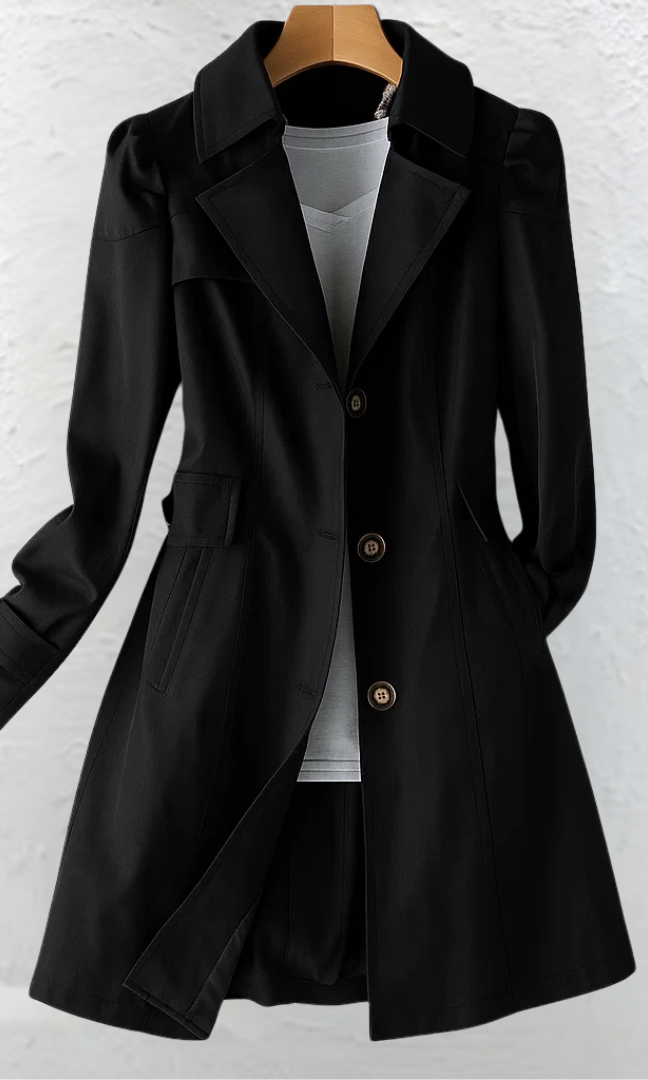 A model smiling while wearing the Adeline trench coat in pink, demonstrating its comfortable and stylish fit.