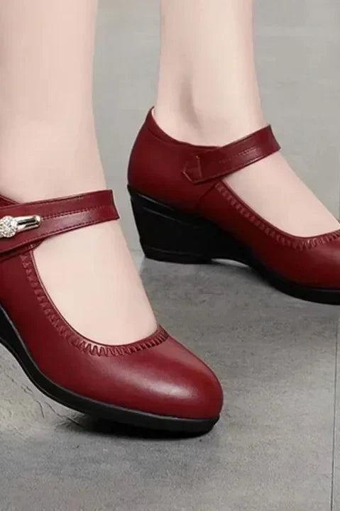 An angled view of the red Alana mid-heel comfort shoes, emphasizing the gentle curve and supportive design.