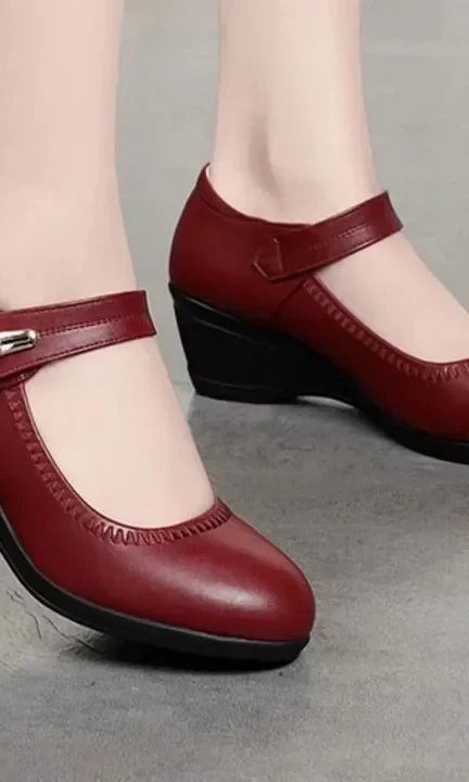 An angled view of the red Alana mid-heel comfort shoes, emphasizing the gentle curve and supportive design.