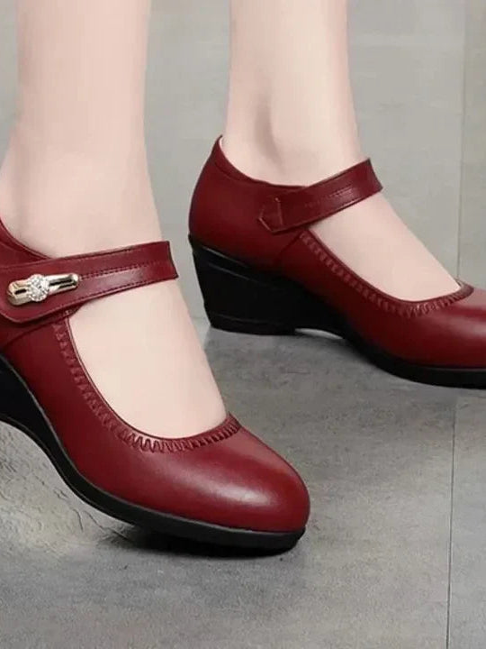 An angled view of the red Alana mid-heel comfort shoes, emphasizing the gentle curve and supportive design.