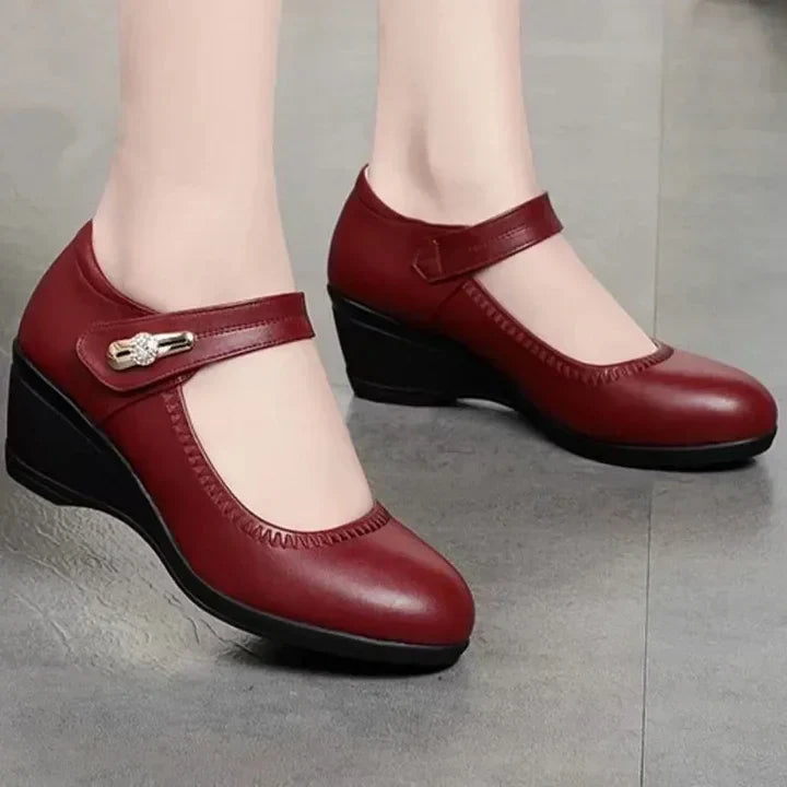 An angled view of the red Alana mid-heel comfort shoes, emphasizing the gentle curve and supportive design.