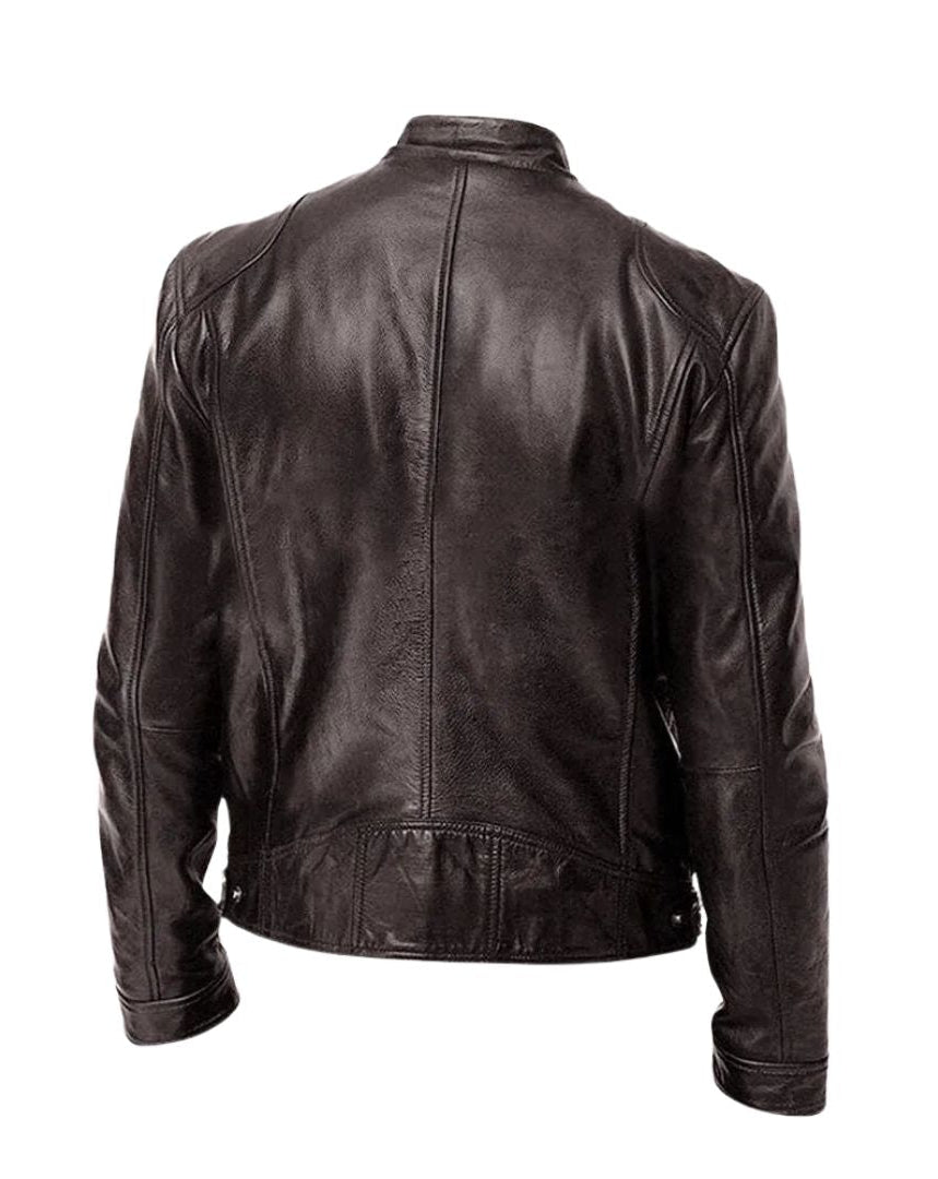A grey Alden men's leather jacket draped over a chair, illustrating its relaxed yet refined presence.
