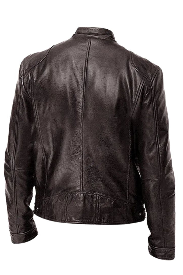 A grey Alden men's leather jacket draped over a chair, illustrating its relaxed yet refined presence.