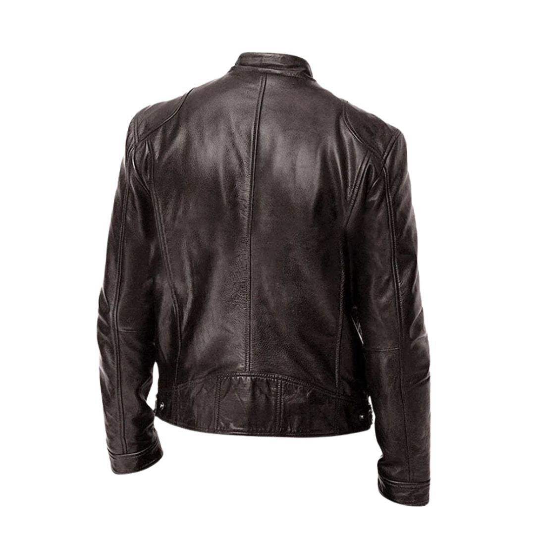 A grey Alden men's leather jacket draped over a chair, illustrating its relaxed yet refined presence.
