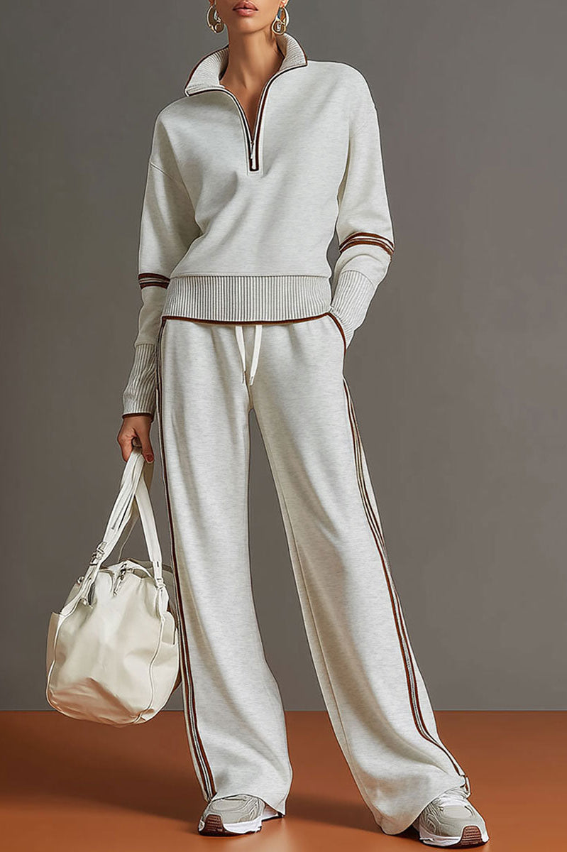 Woman wearing Anouk relaxed fit pants in a neutral tone, showcasing the comfortable wide-leg design in a dynamic pose.