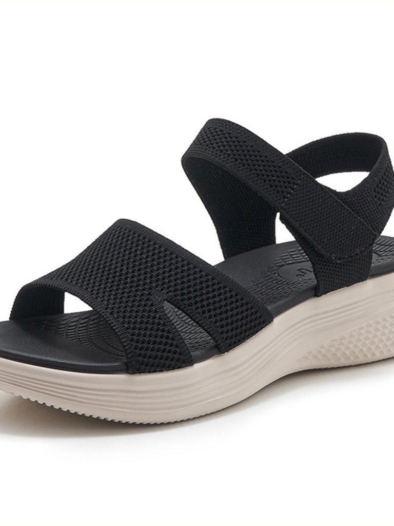 Close-up detail of the green arch support walking sandals, focusing on the texture of the straps and stitching.