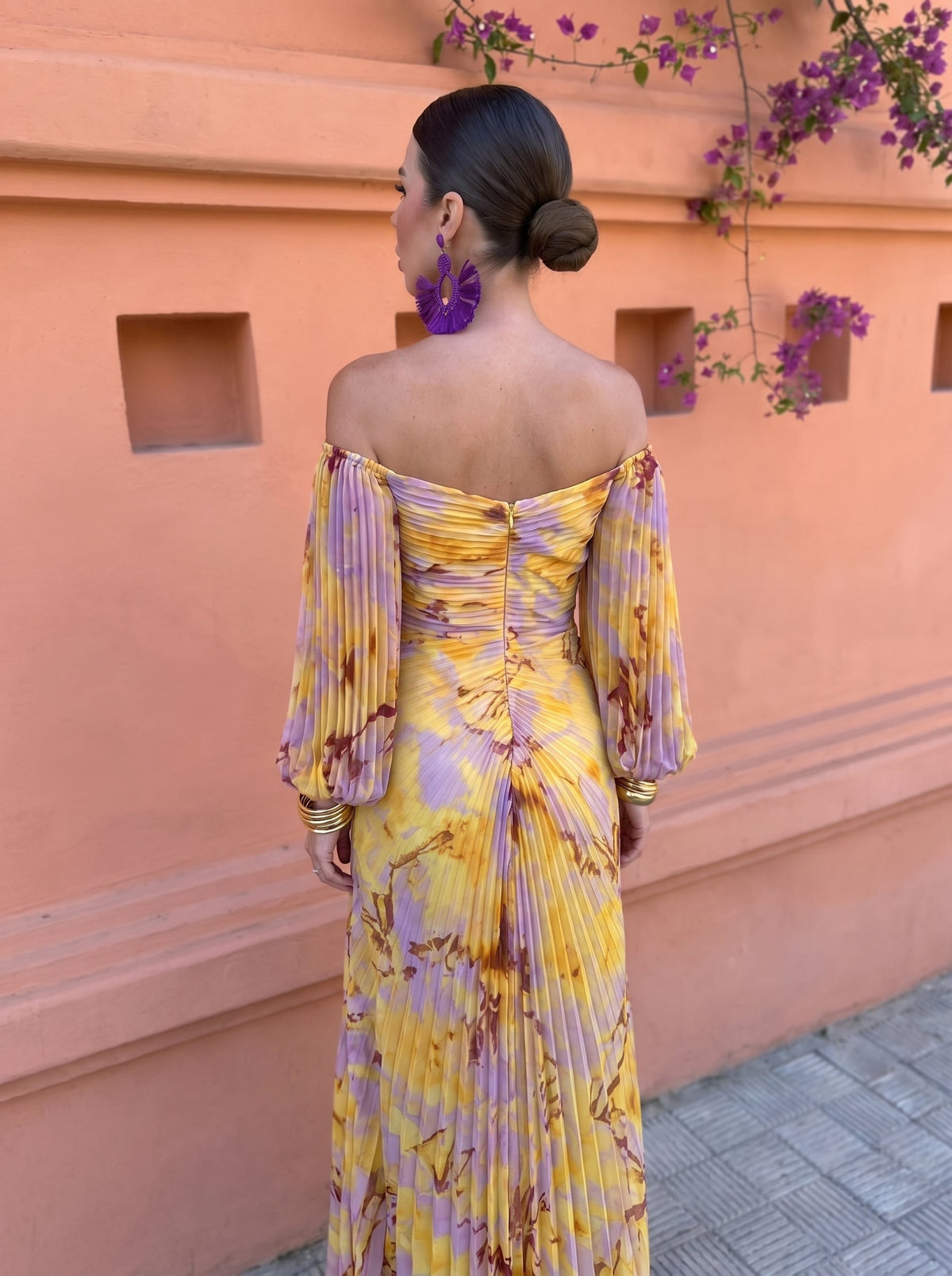 Side view of a woman wearing the tummy-flattering floral maxi dress, highlighting the graceful side slit detail.