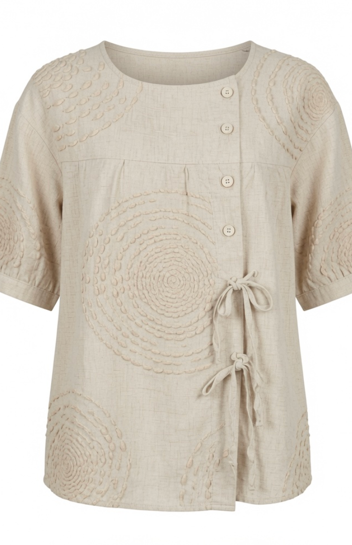 Close-up detail of the raised circular embroidery on the Seraphina casual top, highlighting its texture.