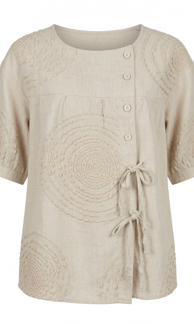 Close-up detail of the raised circular embroidery on the Seraphina casual top, highlighting its texture.