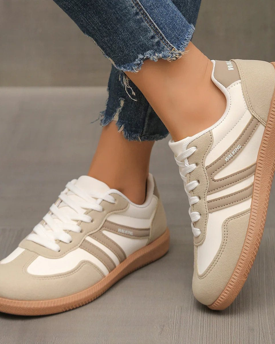 Side profile of an Elara orthopaedic cushioned trainer in off-white, showcasing its sleek design and supportive sole.