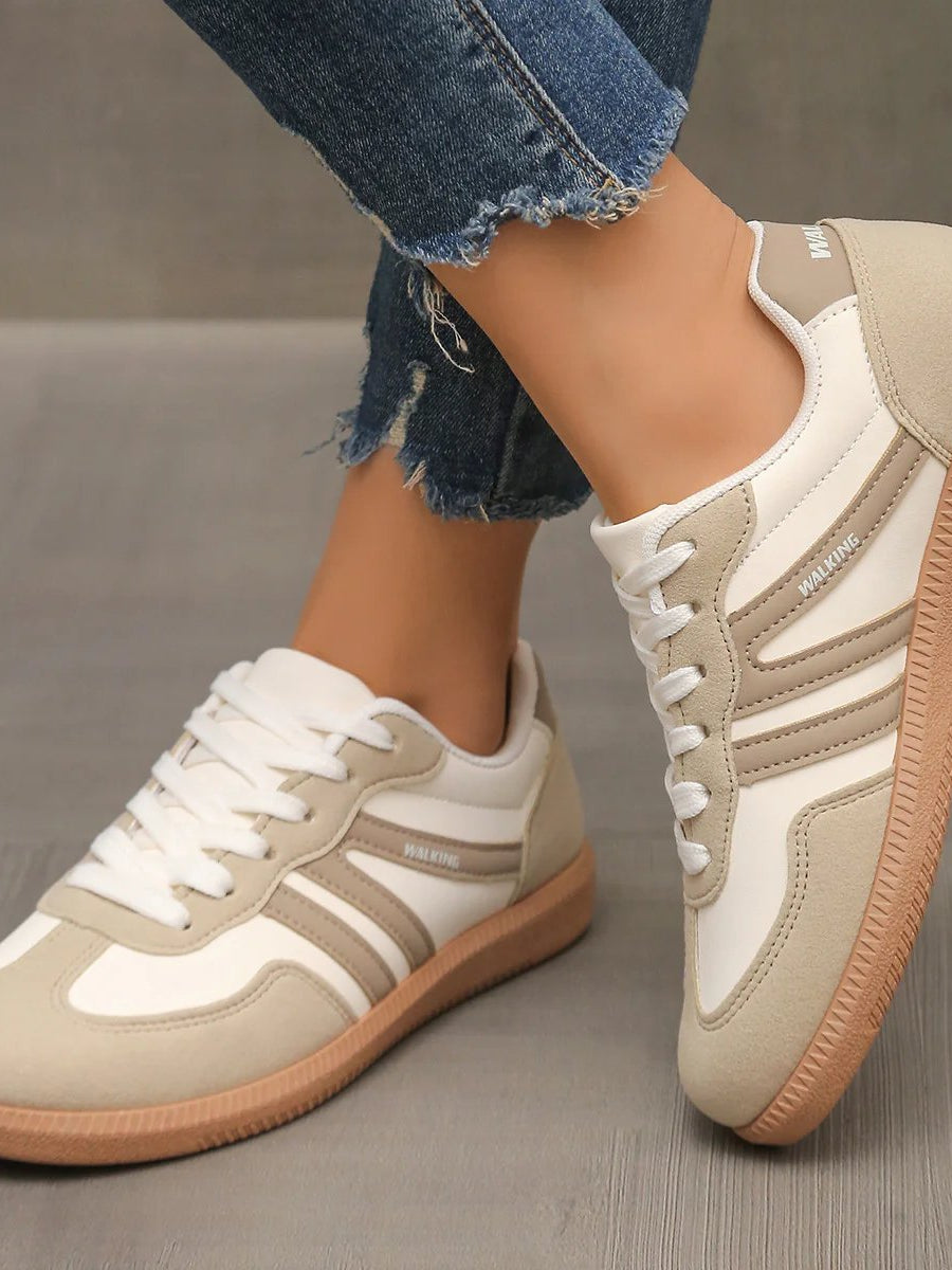Side profile of an Elara orthopaedic cushioned trainer in off-white, showcasing its sleek design and supportive sole.