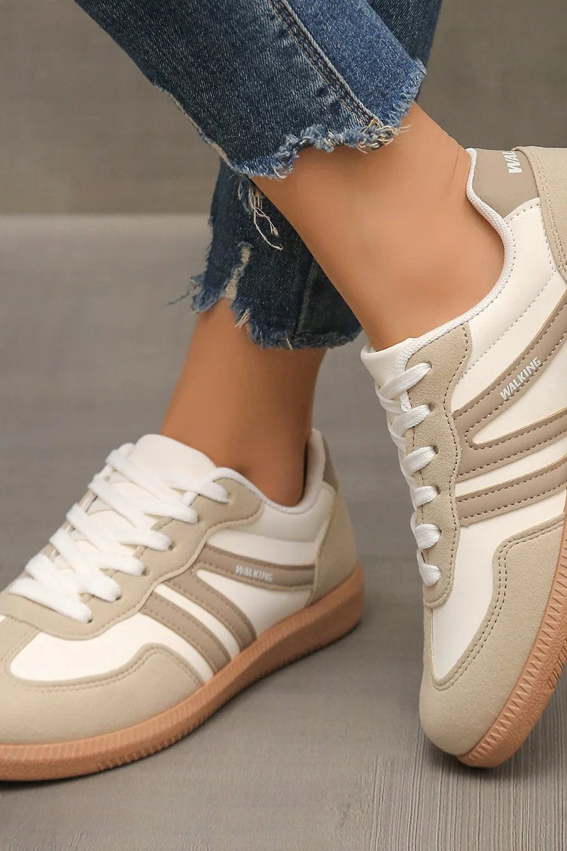 Side profile of an Elara orthopaedic cushioned trainer in off-white, showcasing its sleek design and supportive sole.