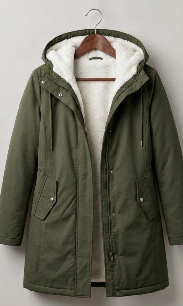 Lifestyle shot of a woman comfortably walking in the Elara parka during a brisk, rainy morning.