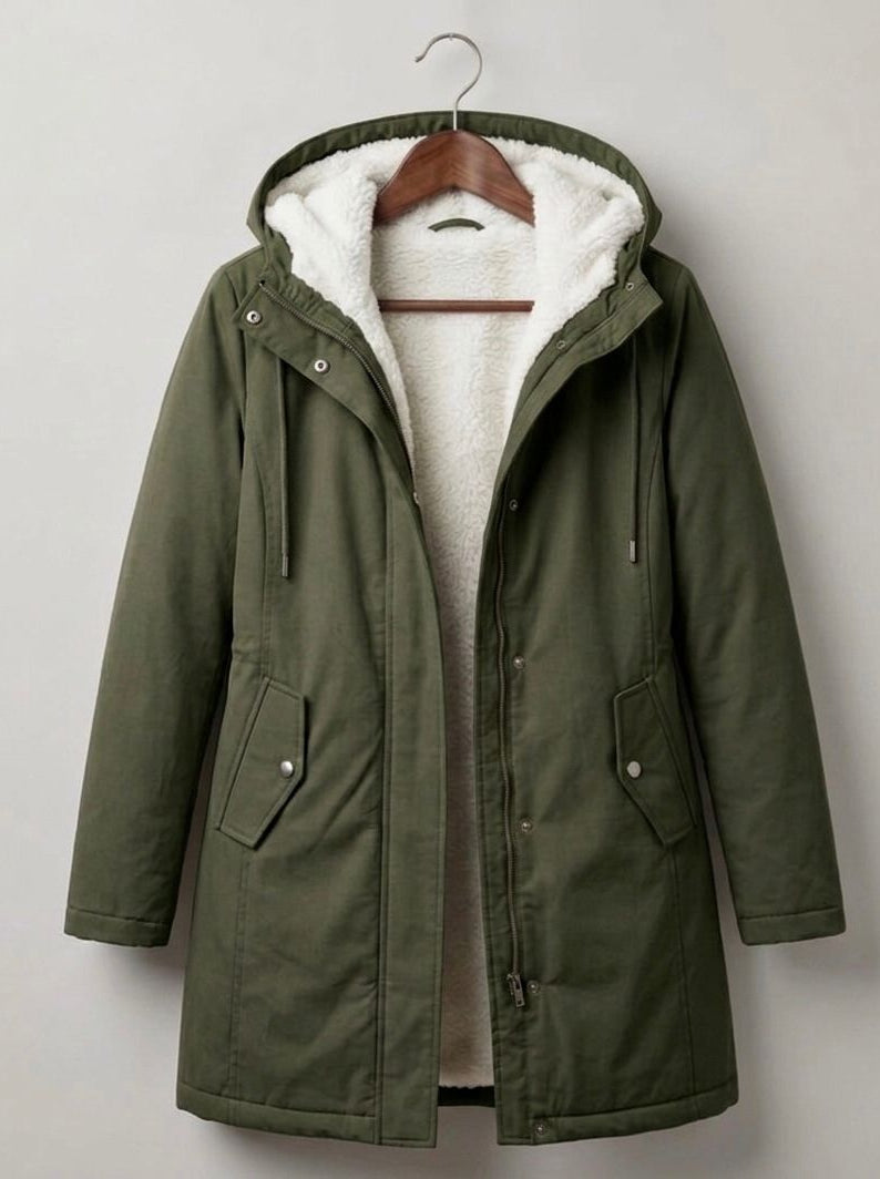 Lifestyle shot of a woman comfortably walking in the Elara parka during a brisk, rainy morning.