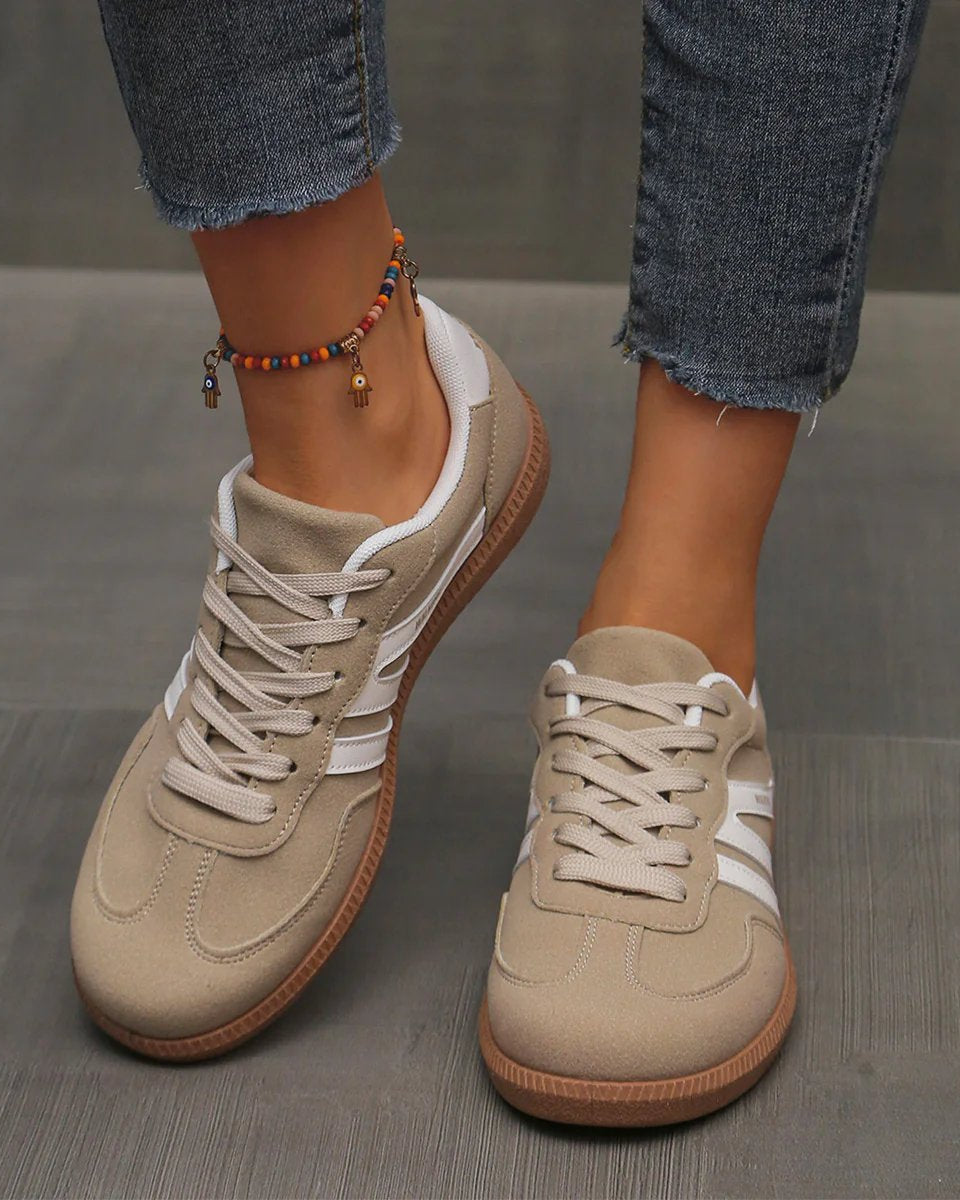 Woman wearing wine red Elara orthopaedic cushioned trainers, styled with casual attire for a comfortable everyday outfit.