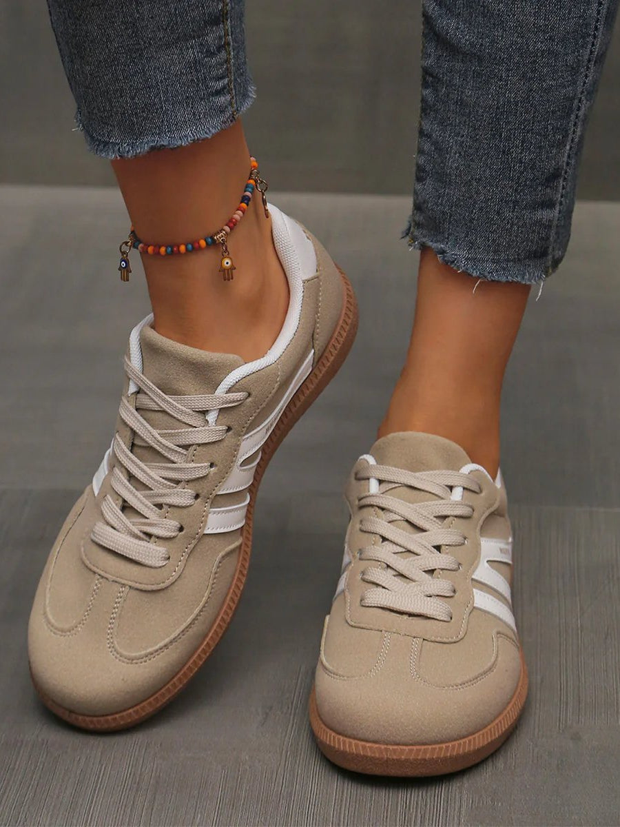 Woman wearing wine red Elara orthopaedic cushioned trainers, styled with casual attire for a comfortable everyday outfit.