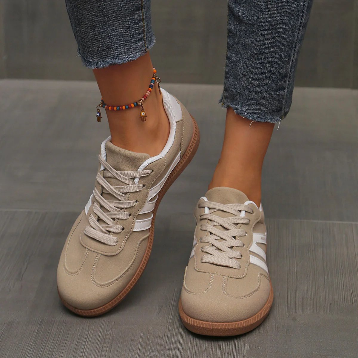 Woman wearing wine red Elara orthopaedic cushioned trainers, styled with casual attire for a comfortable everyday outfit.