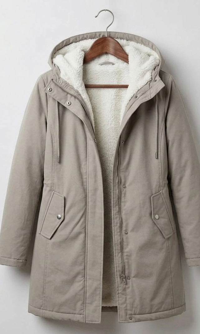 Detail of the Elara parka's pocket, emphasizing its practical design for keeping essentials dry.