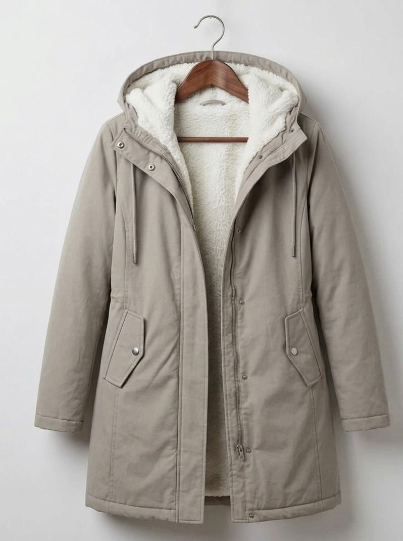 Detail of the Elara parka's pocket, emphasizing its practical design for keeping essentials dry.