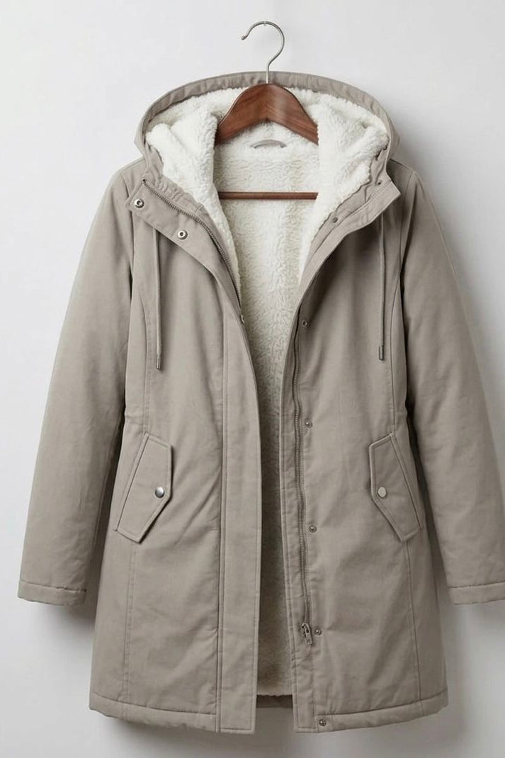 Detail of the Elara parka's pocket, emphasizing its practical design for keeping essentials dry.