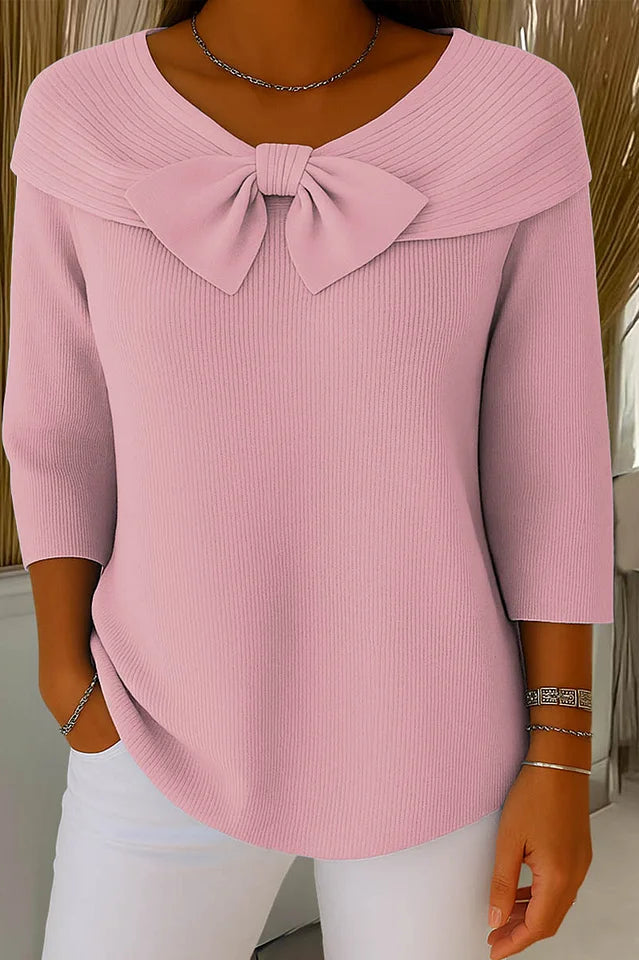 Close-up detail of the bow embellishment on the Elara knitted top, highlighting the fabric texture and craftsmanship.