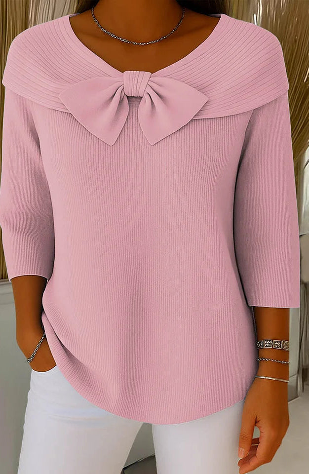 Close-up detail of the bow embellishment on the Elara knitted top, highlighting the fabric texture and craftsmanship.