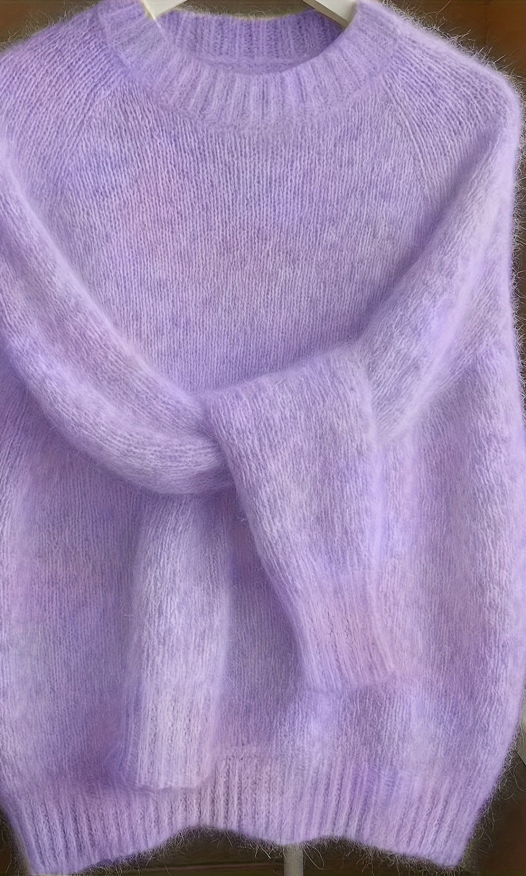 Close-up detail of the fine knit texture and luxurious feel of the purple Elara cashmere-blend sweater.
