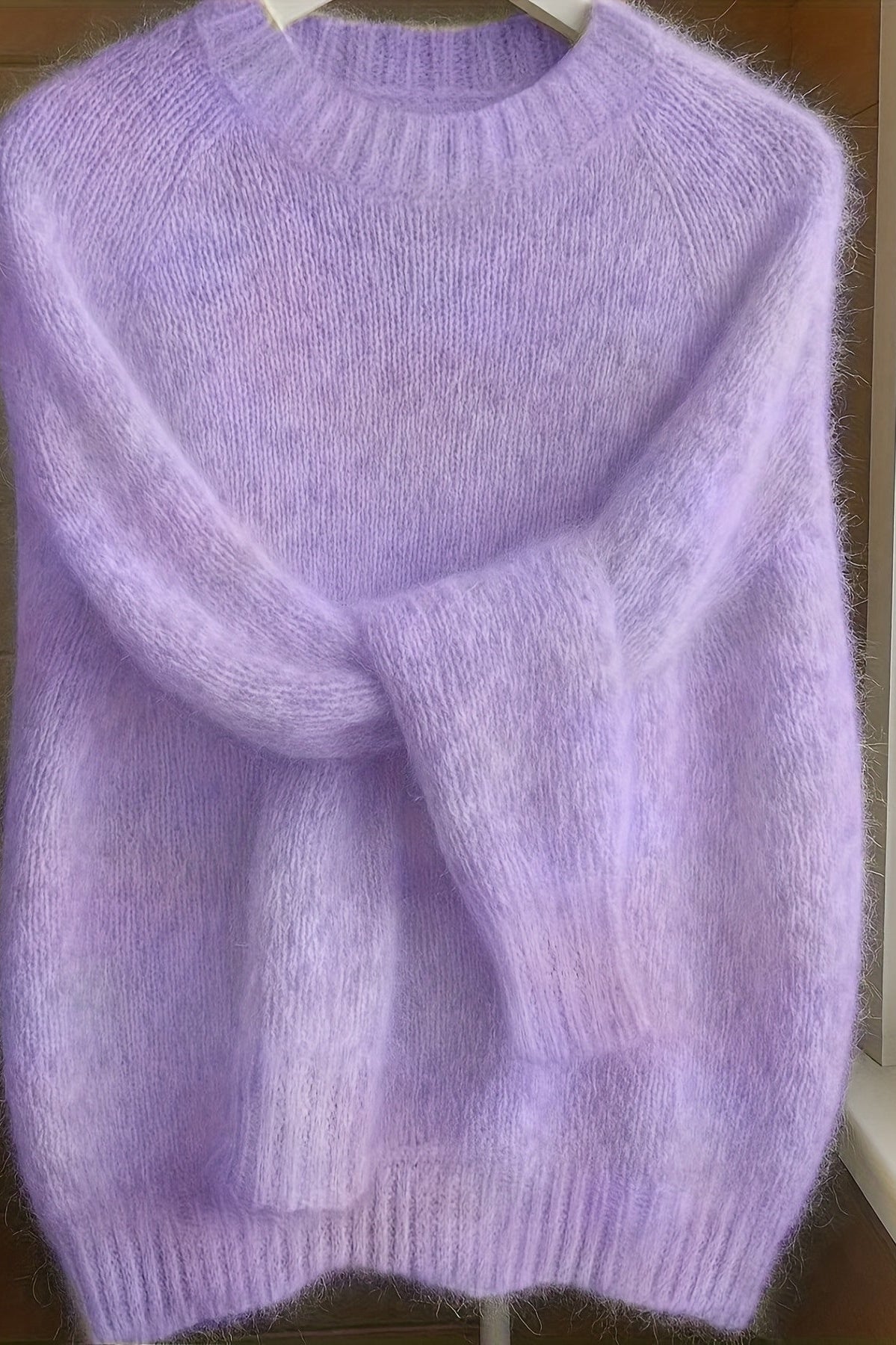 Close-up detail of the fine knit texture and luxurious feel of the purple Elara cashmere-blend sweater.