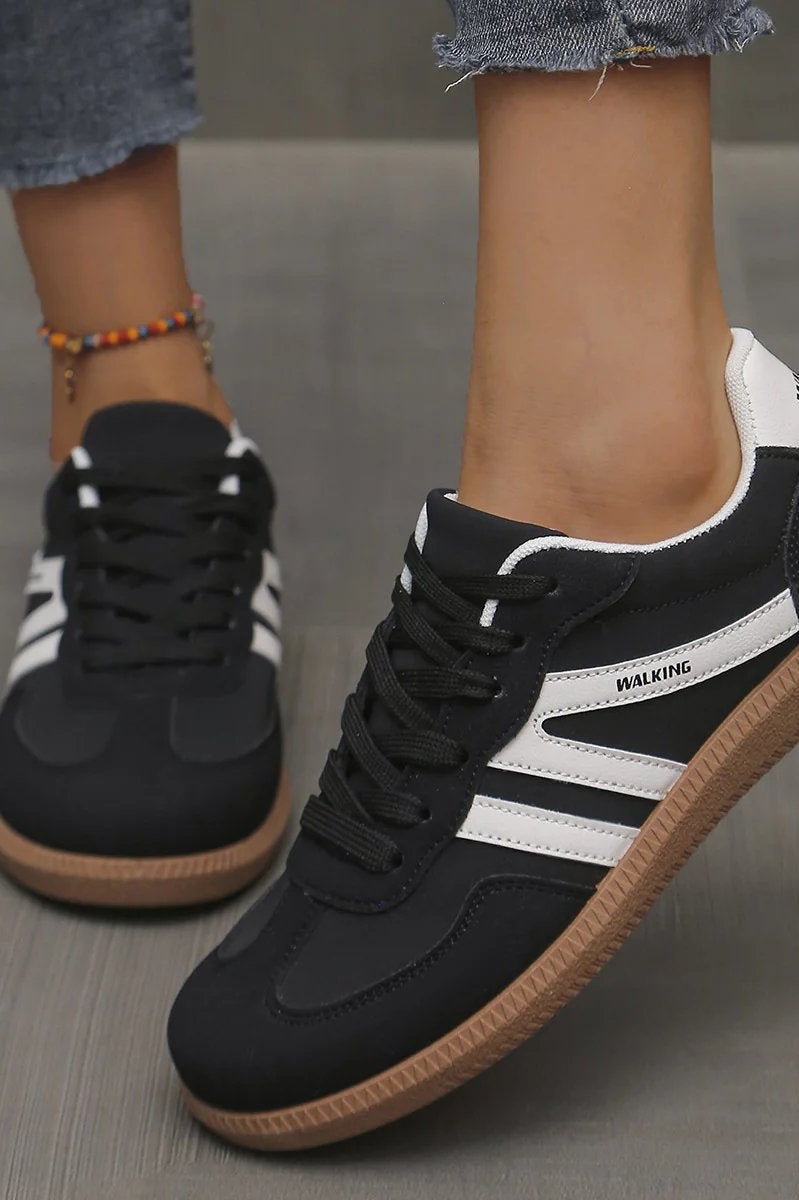 Frontal view of the off-white Elara orthopaedic cushioned trainer, highlighting the breathable mesh and lace-up detail.