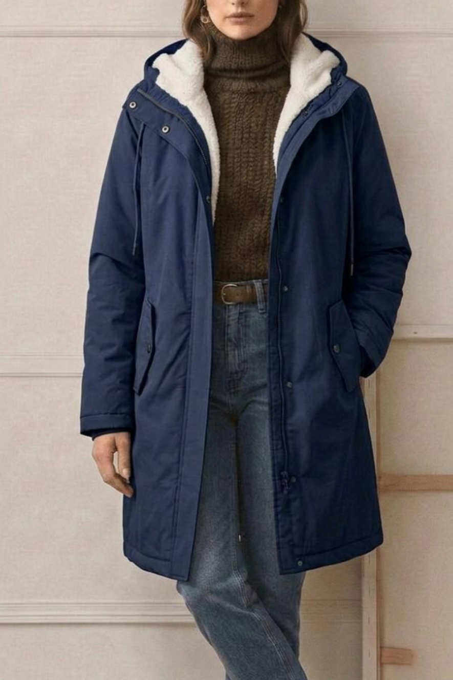 Side profile of the Elara fleece-lined parka, highlighting the length and subtle waist taper for a flattering fit.