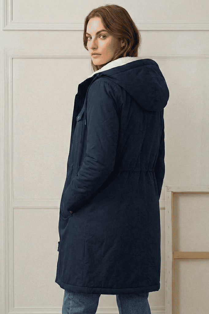 Close-up of the Elara parka's waterproof outer fabric texture, demonstrating its robust rain protection.