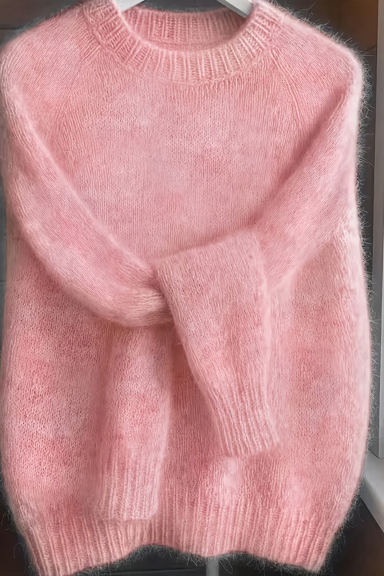 Back view of the soft pink Elara cashmere-blend sweater, showing the smooth fabric and flattering cut.